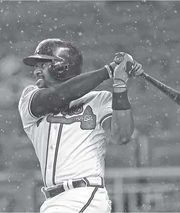  ?? THE ASSOCIATED PRESS ?? The Atlanta Braves' Brandon Phillips drives in a run with a double during the fifth inning of Friday's game against the Milwaukee Brewers in Atlanta. He had a two-run homer and another hit Saturday as the Braves won 3-1.