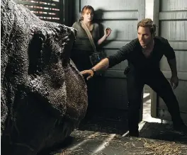  ??  ?? Bryce Dallas Howard, left, and Chris Pratt’s characters are on a mission to rescue the remaining dinosaurs from extinction in Jurassic World: Fallen Kingdom.