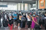  ?? [DANIEL COLE/ THE ASSOCIATED PRESS] ?? People queue in line to check-in for a British Airways flight to Heathrow airport, Friday at Nice airport, southern France.