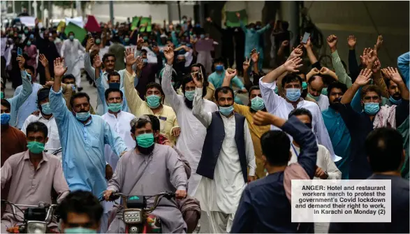  ??  ?? ANGER: Hotel and restaurant
workers march to protest the government’s Covid lockdown and demand their right to work,
in Karachi on Monday (2)