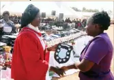  ??  ?? Dr Senelani Hove-Musekwa presents a shield to Coalfields representa­tive Mrs Fortune Mpofu at the Matabelela­nd North Provincial BSPZ merit awards ceremony at Somvubu High School at Inyathi in Bubi District last week