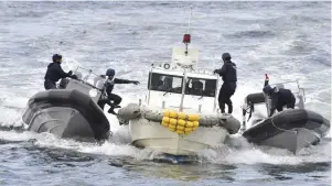  ??  ?? Japan Coast Guard security team members display tracking and capture drills by rigid-hulled inflatable boats against an unidentifi­ed ship at sea in Yokohama near Tokyo during an inspection tour by Philippine President Rodrigo Duterte. —AP