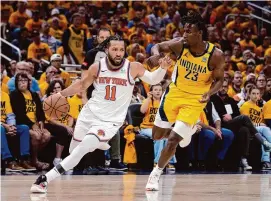  ?? Michael Conroy/Associated Press ?? Knicks guard Jalen Brunson (11) drives past Pacers forward Aaron Nesmith during the first half of Game 3 of their second-round playoff series on Friday.