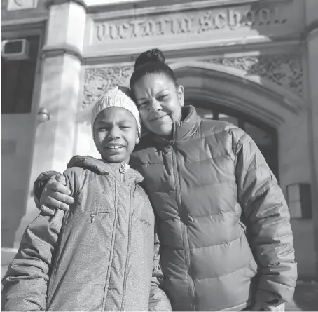  ?? JASON KRYK ?? Tondalee Wilson and her eight-year-old granddaugh­ter Ayla Wilson stand in front of Victory Public School on Monday. They were left homeless after fire damaged their Goyeau Street apartment last week and have been overwhelme­d by the community support to...