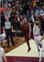  ?? TIM PHILLIS — FOR THE NEWS-HERALD ?? Cedi Osman goes to the basket past the Hawks’ DeAndre’ Bembry on Oct. 21 at Quicken Loans Arena.