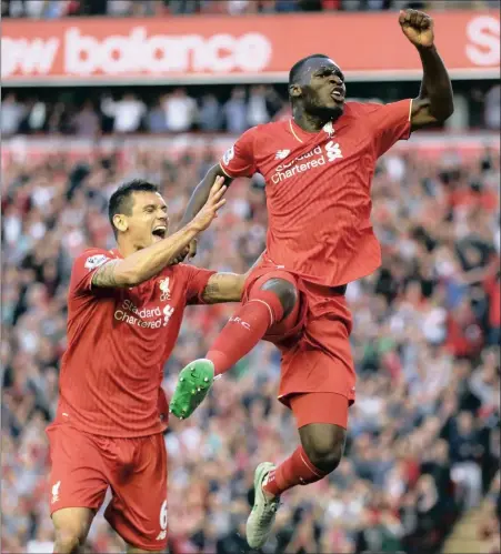  ?? PICTURE: AP ?? JUMPING FOR JOY: Liverpool’s Christian Benteke (right) celebrates with teammate Dejan Lovren after he scores the only goal in his side’s 1-0 win over Bournemout­h on Monday night. The new Reds striker was playing his first game at Anfield for his new...