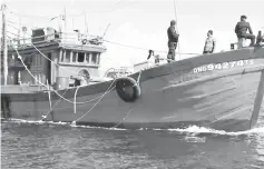  ??  ?? The Vietnamese fishing boat being seized and taken to the jetty at Patau-Patau after it was found to have carried out illegal fishing in the Malaysian waters, yesterday.