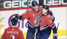  ?? Nick Wass / Associated Press ?? Capitals left wing Alex Ovechkin (8) celebrates his goal with T.J. Oshie (77) and Justin Schultz (2) against the Islanders Tuesday in Washington.