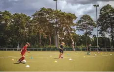  ?? New York Times ?? During a football practice, children train individual­ly with their own balls at clearly marked locations two metres apart in Berlin.