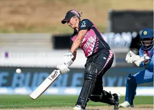  ?? PHOTOSPORT ?? White Ferns opening bat Sophie Devine strikes a lofted drive on her way to 72 from 52 balls against India in Hamilton yesterday.