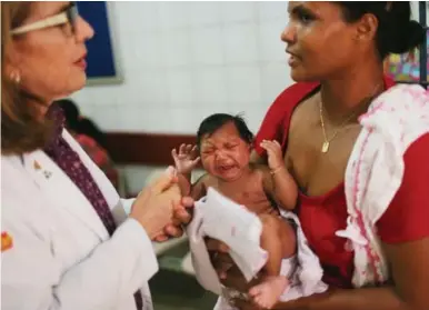  ?? MARIO TAMA PHOTOS/GETTY IMAGES ?? The mosquito-borne Zika virus has been linked in Brazil to a 20-fold increase of microcepha­ly — babies born with small heads — and brain damage. Several countries are under a travel advisory because of the pathogen.