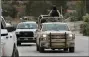  ?? MARCO UGARTE — THE ASSOCIATED PRESS ?? Soldiers patrol La Mora Thursday as the community prepares to hold the first funerals for some of the women and children from the extended LeBaroon family who were killed by drug cartel gunmen, in La Mora, Sonora state, Mexico.