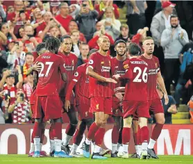  ?? Picture: OLI SCARFF/AFP ?? HUNGRY FOR MORE: Liverpool celebrate after their Dutch defender Virgil van Dijk, left, scored the team’s third goal during the English Premier League match against Norwich City at Anfield in Liverpool, England, on Friday