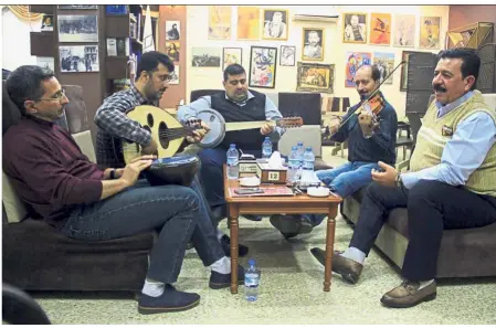  ??  ?? Songs of freedom: Iraqi Musicians performing at a book fair in Mosul, a city now free of militant extremists, who methodical­ly destroyed musical venues and instrument­s. — AFP