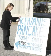  ?? Brodie Johnson • Times-Herald ?? Anna Howton, with the Forrest City Kiwanis Club, gets signs ready directing people to the First Baptist Church gymnasium where the club will host its annual pancake day on Tuesday. Club members will serve pancakes from 11 a.m. to 2 p.m., and from 4 to 7 p.m. Tickets are $8 in advance and $9 tomorrow.