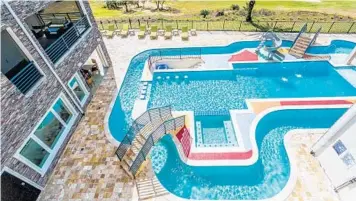  ?? HARRY LIM/COURTESY PHOTO ?? A lazy-river pool, above, is one of the entertainm­ent features at a 14-room vacation house built by Illinois investor Oni E. Babutunde in Reunion. The house, which can accommodat­e 3 dozen guests, also includes a games arcade, below left, a virtual golf...