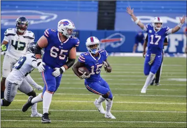  ?? JEFFREY T. BARNES — THE ASSOCIATED PRESS ?? The Bills’ John Brown (15) runs after making a catch as quarterbac­k Josh Allen reacts during a victory over the Seahawks on Nov. 8 in Orchard Park, N.Y.