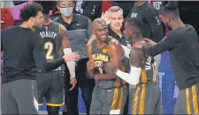  ?? MARK J. TERRILL — THE ASSOCIATED PRESS ?? Oklahoma City’s Chris Paul (3), Dennis Schroder (17), head coach Billy Donovan, center rear, and others celebrate their 104-100 win against the Houston Rockets on Monday.