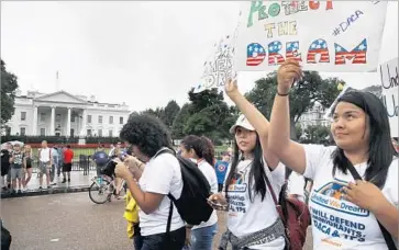  ?? Jacquelyn Martin Associated Press ?? BENEFICIAR­IES of the Deferred Action for Childhood Arrivals program and supporters rally outside the White House last month. The White House says President Trump will reveal the fate of the program Tuesday.