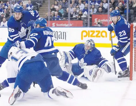  ?? CHRIS YOUNG/THE CANADIAN PRESS ?? A bevy of Toronto Maple Leafs scramble to keep the puck out of the net in Monday’s game against Tampa Bay.