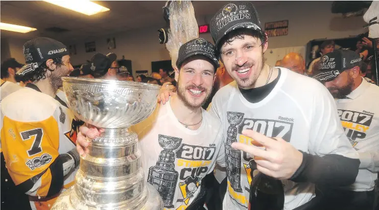  ?? — GETTY IMAGES FILES ?? Sidney Crosby, left, and Evgeni Malkin celebrate with the Stanley Cup in the locker-room after clinching victory in Game 6 of the NHL Stanley Cup Final.