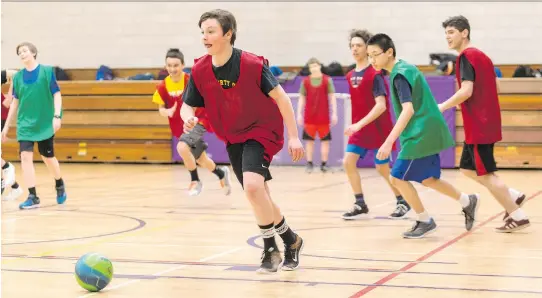  ?? ERROL MCGIHON ?? A boys’ gym class plays indoor soccer at Nepean High School. Nepean boasts 11 full- or part-time teachers teaching phys-ed, a fitness program or outdoor education.