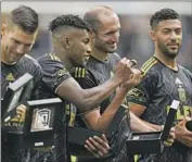  ?? Jae C. Hong Associated Press ?? BEFORE BEATING Portland, LAFC players line up to collect their 2022 MLS Cup championsh­ip rings.