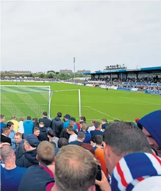  ?? ?? Rangers fans pack into Peterhead’s Balmoor stadium to watch their club in Scottish senior football’s bottom tier . . .