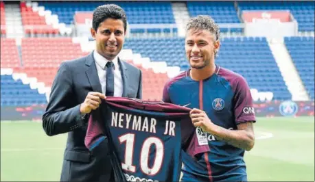  ?? AFP ?? Neymar (R) holds up his jersey alongwith PSG president Nasser AlKhelaifi during his official presentati­on at the Parc des Princes stadium on Friday.