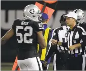  ?? ERIC RISBERG — THE ASSOCIATED PRESS ?? Referee Gene Steratore carries a folded piece of paper used to determine a measuremen­t next to the Raiders’ Khalil Mack during the second half of Sunday’s game.