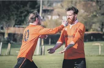  ?? PICTURE BY PAUL PAXFORD ?? Peter Caveney and Andy Gould celebate one of East Dean’s goals against Petworth