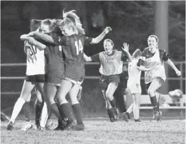  ?? BRIAN KRISTA/CARROLL COUNTY TIMES ?? Century’s girls soccer team rush the field to celebrate their 1-0 win over Liberty during a girls soccer playoff game at Century High School on Tuesday.