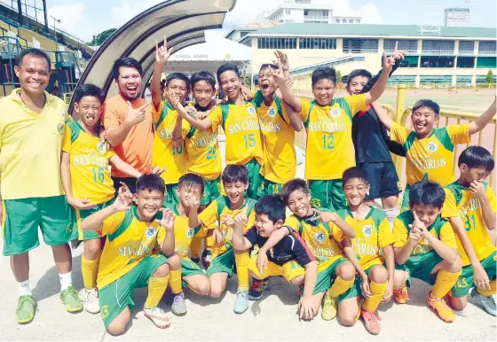  ?? (SUN.STAR FOTO/ARNI ACLAO) ?? NEW CHAMPIONS. Coach Edwin Arganza (left) celebrates his first Cebu City Olympics elementary crown after a 2-0 win over SHS-Hijas de Jesus.