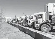  ?? [PHOTOS PROVIDED] ?? Compressed natural gas-powered trash trucks are fueled at Moore’s new filling station.