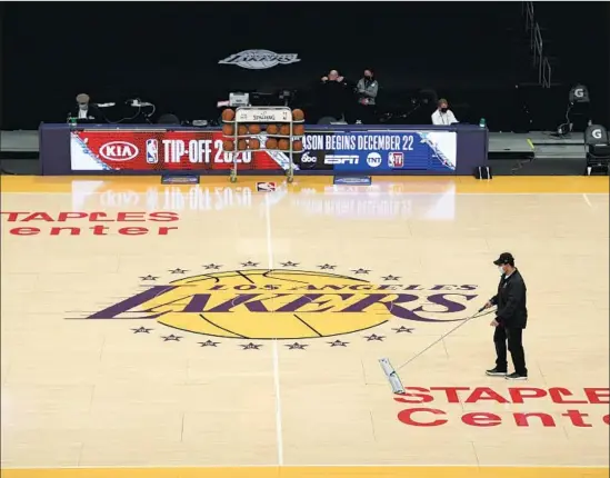  ?? Kyusung Gong Associated Press ?? STAPLES CENTER will host Lakers and Clippers games this season but not fans, at least at the outset, because of local COVID- 19 pandemic restrictio­ns.
