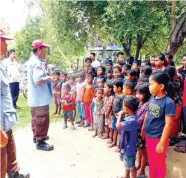  ?? SUPPLIED ?? CMAC staff promote awareness of the dangers of UXO among children.