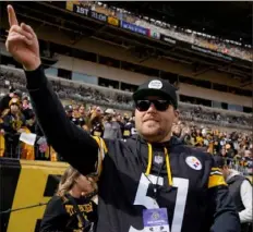  ?? Associated Press ?? Pirates relief pitcher David Bednar gestures to fans during warmups before a game between the Baltimore Ravens and the Steelers on Oct. 8 at Acrisure Stadium.