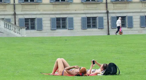 ?? (Radaelli) ?? In costume Due donne prendono il sole davanti alla Villa Reale di Monza. Il sindaco Allevi vuole vietare l’abbronzatu­ra davanti allo storico edificio