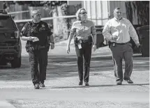  ?? Josie Norris/staff photograph­er ?? Law enforcemen­t officials leave the scene of an officerinv­olved shooting at a home in the 11900 block of Bammel on the North Side. An officer shot and killed a 33-year-old man.