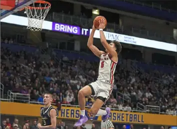  ?? Sebastian Foltz/Post-Gazette ?? Moon’s Elijah Guillory goes up for a dunk against Franklin Regional in the WPIAL Class 5A championsh­ip March 1 at Petersen Events Center. The two teams meet again Monday in the state semifinals.