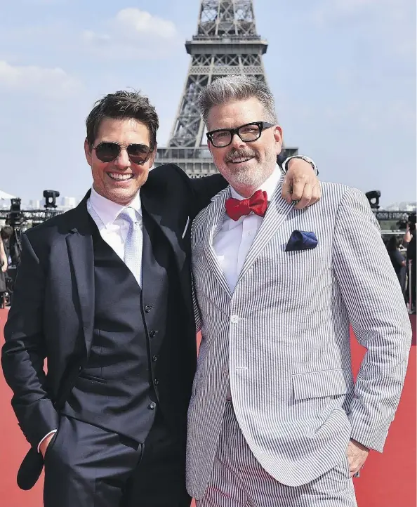  ?? GETTY IMAGES ?? Director Christophe­r McQuarrie, right, seen with Mission: Impossible — Fallout star Tom Cruise at the Paris première of the new action flick, is the first director to return to a Mission: Impossible sequel.