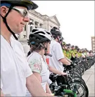  ?? Arkansas Democrat-gazette/celia STOREY ?? Jim Britt stands with fellow bike advocates below the steps of the state Capitol at sunset May 16 during the annual Ride of Silence, a memorial for all bicyclists killed or injured in traffic accidents. Each rider carried the name of one of more than...