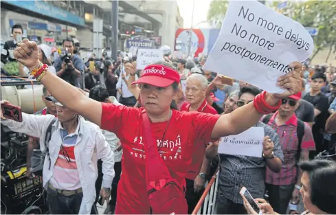  ?? WICHAN CHAROENKIA­TPAKUL ?? Pro-democracy activists gather at the Ratchapras­ong intersecti­on to protest against any further poll delays and are scheduled to gather again next Saturday if a royal decree calling for the election is not published in the ‘Royal Gazette’ by Friday.