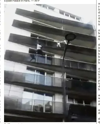  ?? — AP ?? Selfless act: Gassama scaling an apartment building to save a young child dangling from a balcony in Paris.