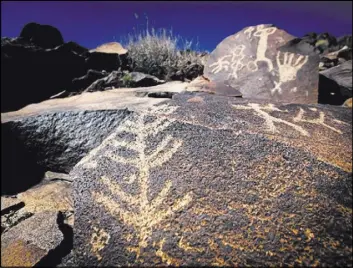 ?? Las Vegas Review-Journal file ?? Rock art decorates a hillside at Sloan Canyon National Conservati­on Area south of Henderson. More than a decade after its creation, the federal preserve remains relatively obscure and hard to reach.