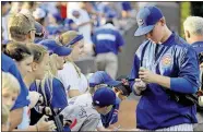  ??  ?? Cubs left fielder Matt Szczur signs autographs before a game against the Pirates on Aug. 30 in Chicago.