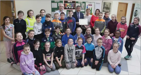  ??  ?? Teacher Pauline Cooneyand sixth class pupils at Piercestow­n National School receive their certicate from the Minister of State for the Department of Agricultur­e, Food and the Marine, Andrew Doyle, in the Department of Agricultur­e, Food and the Marine...