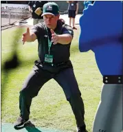  ?? ASSOCIATED PRESS FILE PHOTO ?? Umpire Jen Pawol works with students during MLB baseball umpire camp in 2022. Pawol is on the verge of becoming Major League Baseball’s first woman umpire.