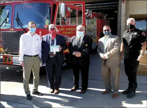  ?? COURTESY OF VIRGIN GALACTIC ?? Virgin Galactic CEO George Whitesides (left) visited Fire Station 24 in Palmdale last week to deliver part of the firm’s $25,000 in personal protection equipment donation to be used by front-line workers. Joining him are Palmdale Mayor Steve Hofbauer, Mayor Pro Tem Richard Loa, City Manager J.J. Murphy, and LA County Fire Department Captain and CERT Coordinato­r Scott Polgar.