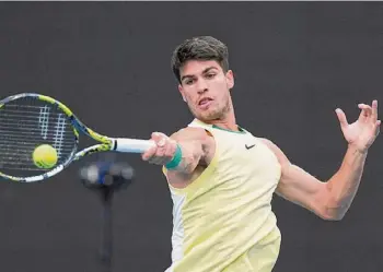  ?? Andy Wong/associated Press ?? Carlos Alcaraz plays a forehand return to Miomir Kecmanovic during their fourth-round match at the Australian Open Monday in Melbourne, Australia.